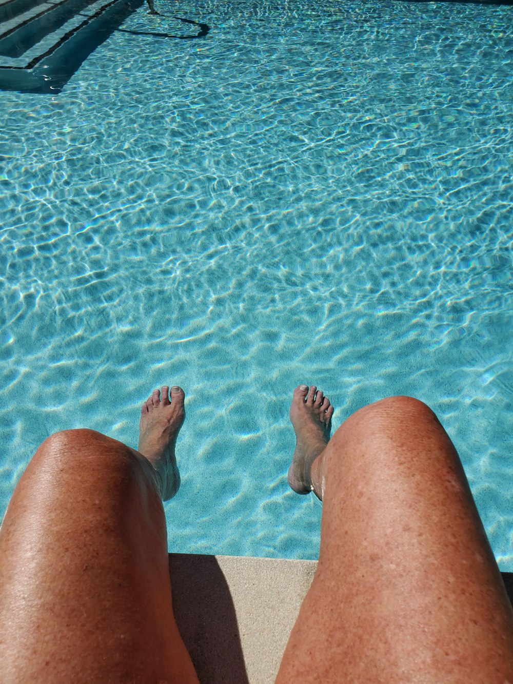 person sitting on the swimming pool