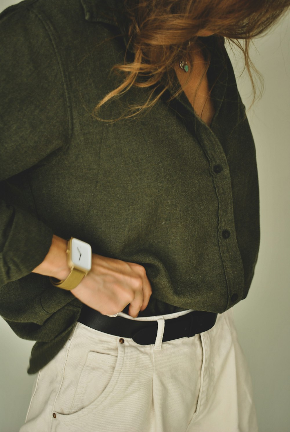 woman in black button up shirt and white pants