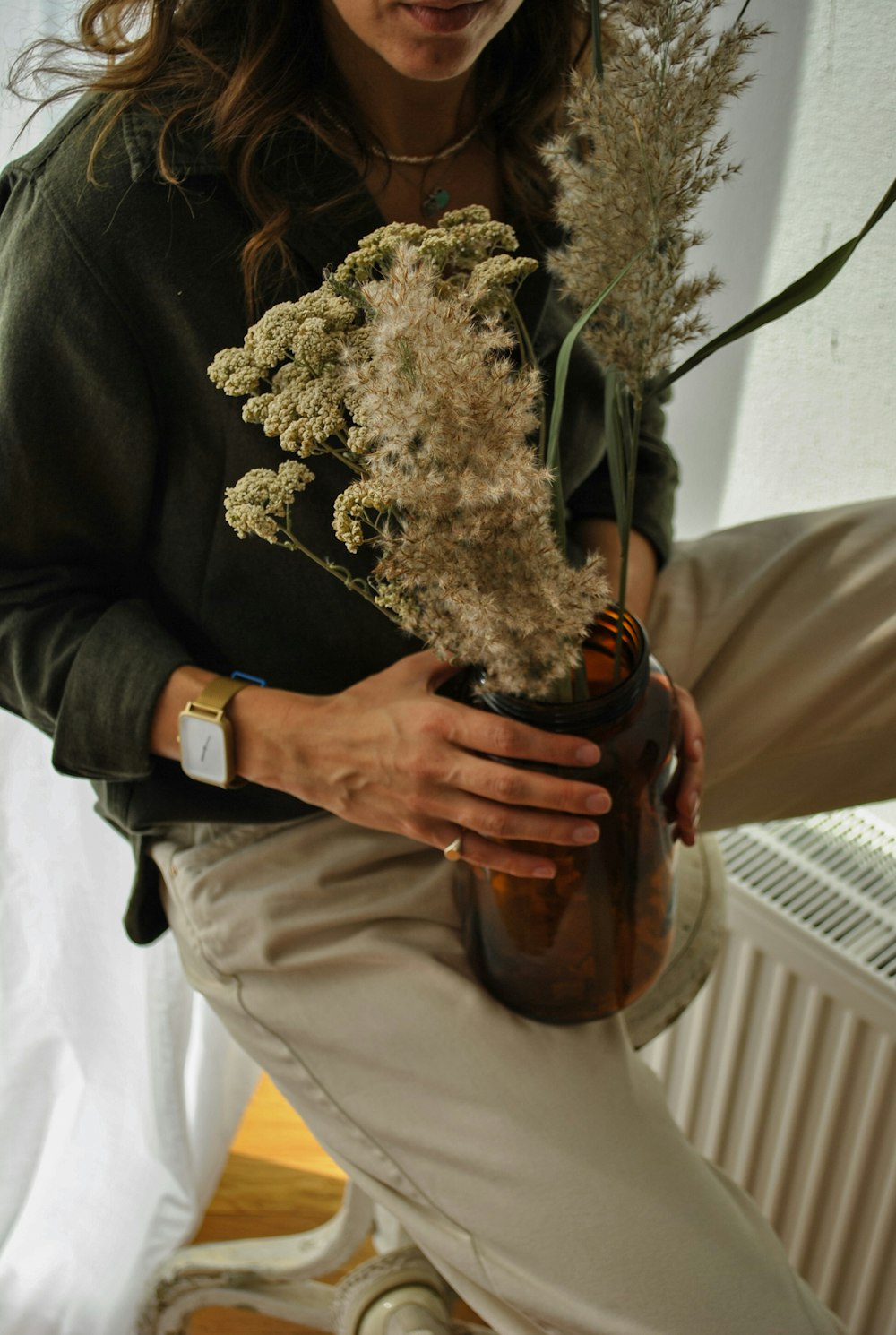 person holding bouquet of white flowers