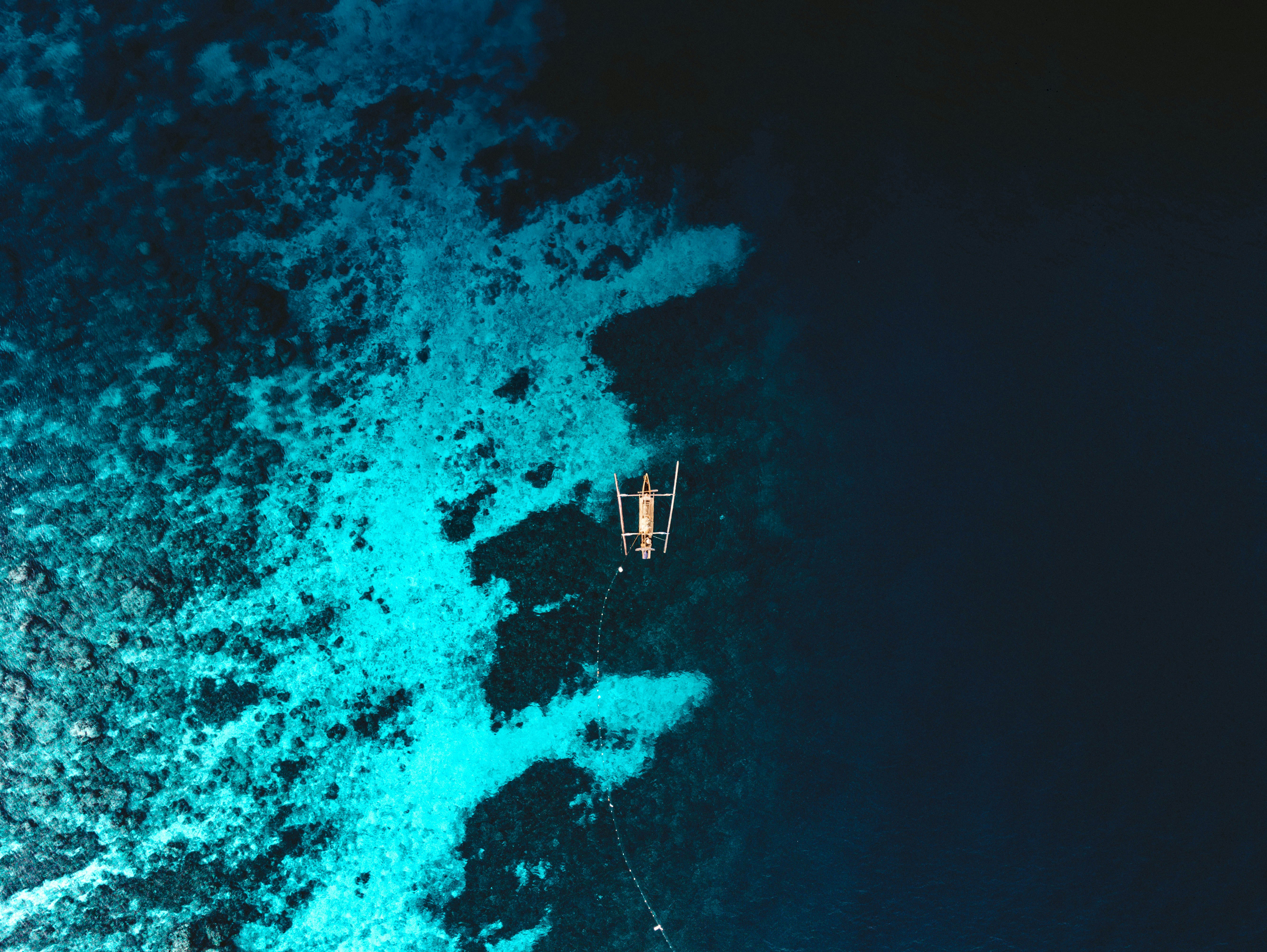 white-boat-on-blue-body-of-water