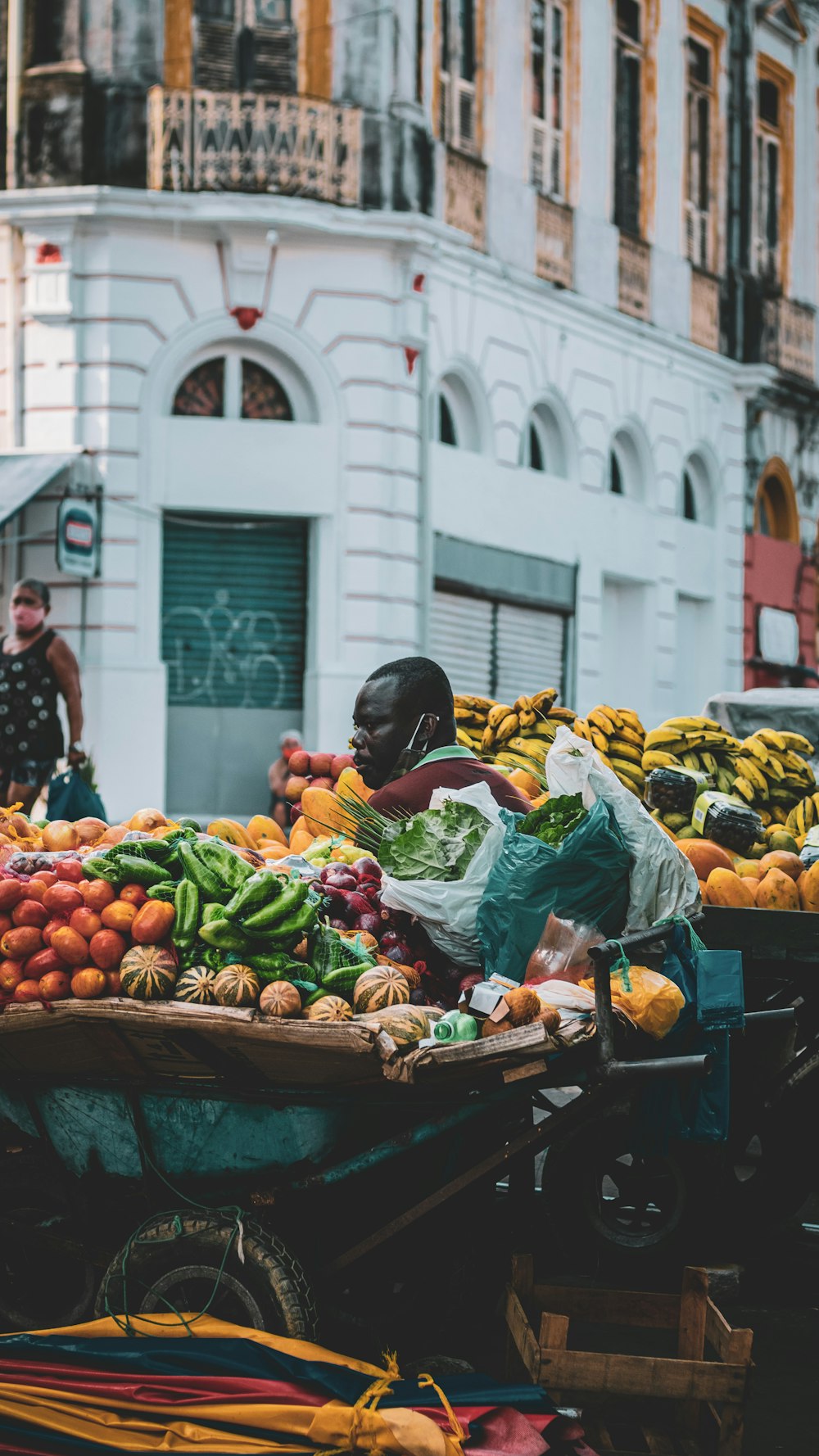 woman in black jacket holding green vegetable