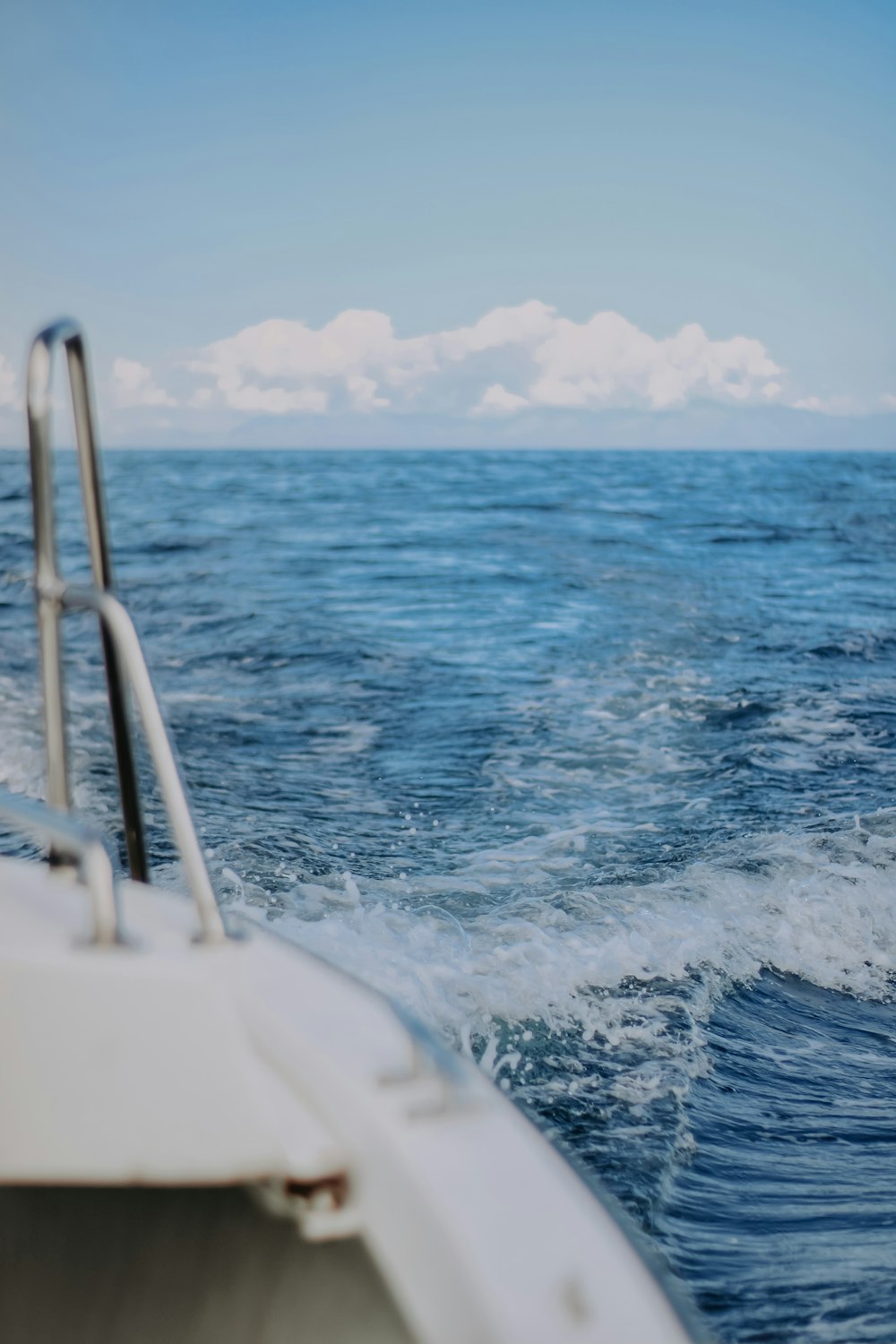 white boat on sea during daytime