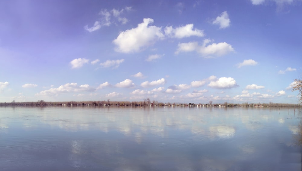 blue sky and white clouds over lake