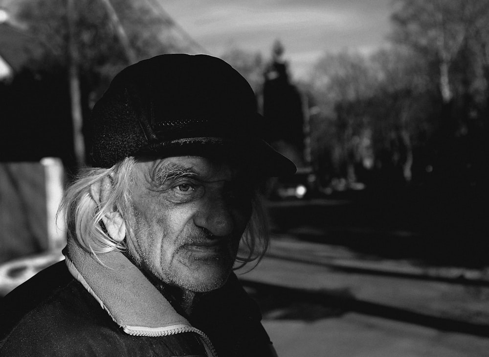 grayscale photo of woman in black jacket and knit cap