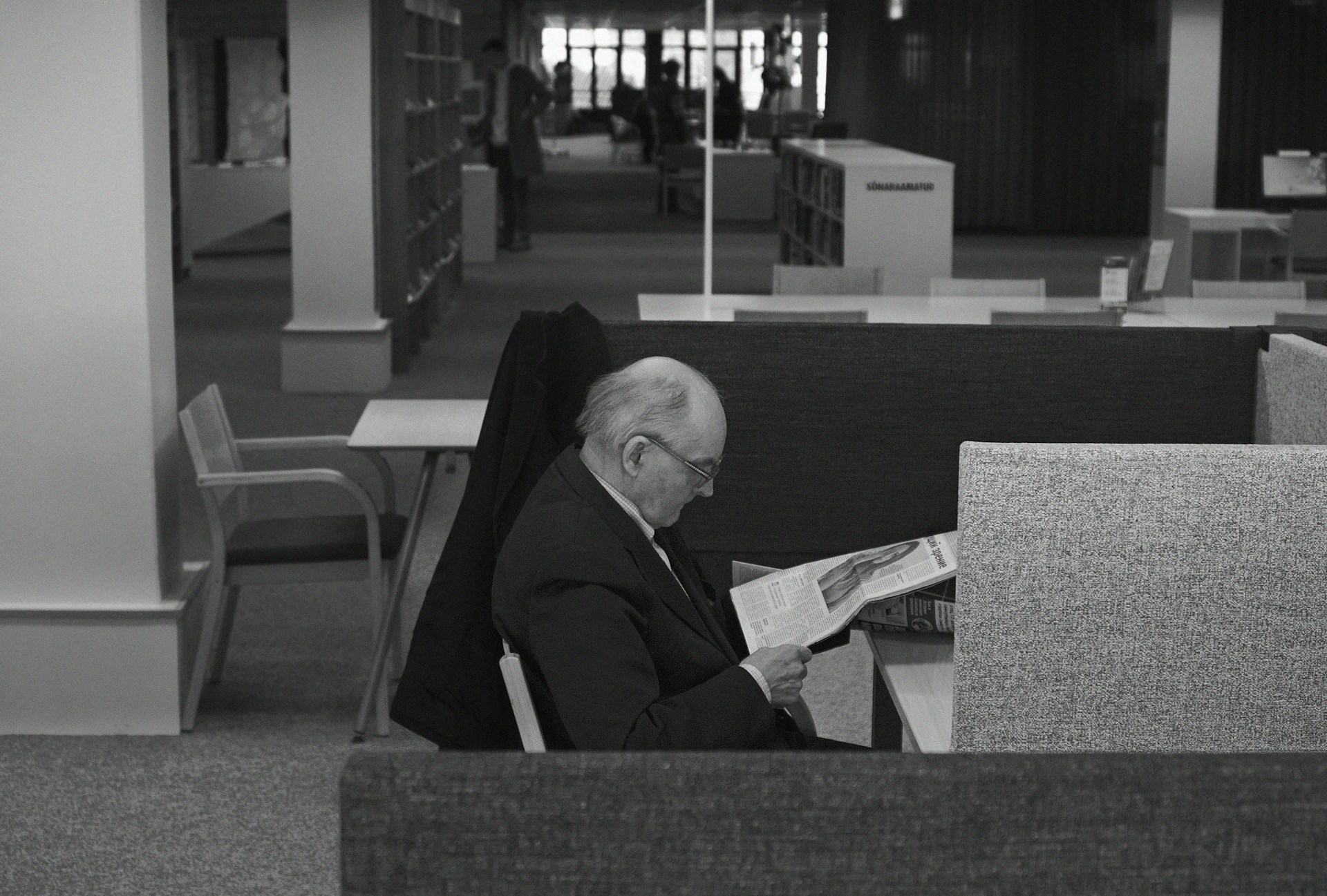 man in black coat sitting on chair
