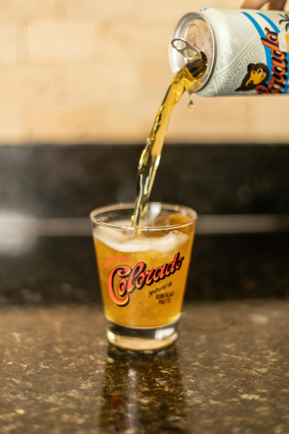 clear drinking glass with yellow liquid