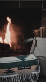 A caring volunteer handing a warm blanket to a family affected by fire.