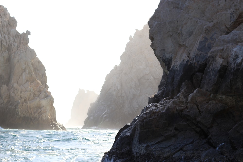 white rock formation near body of water during daytime