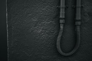 Hands holding flexible PVC conduit pipe ready for installation.