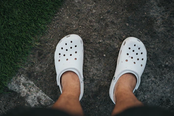 person wearing white rubber clog