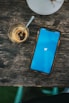 blue ipod touch on brown wooden table
