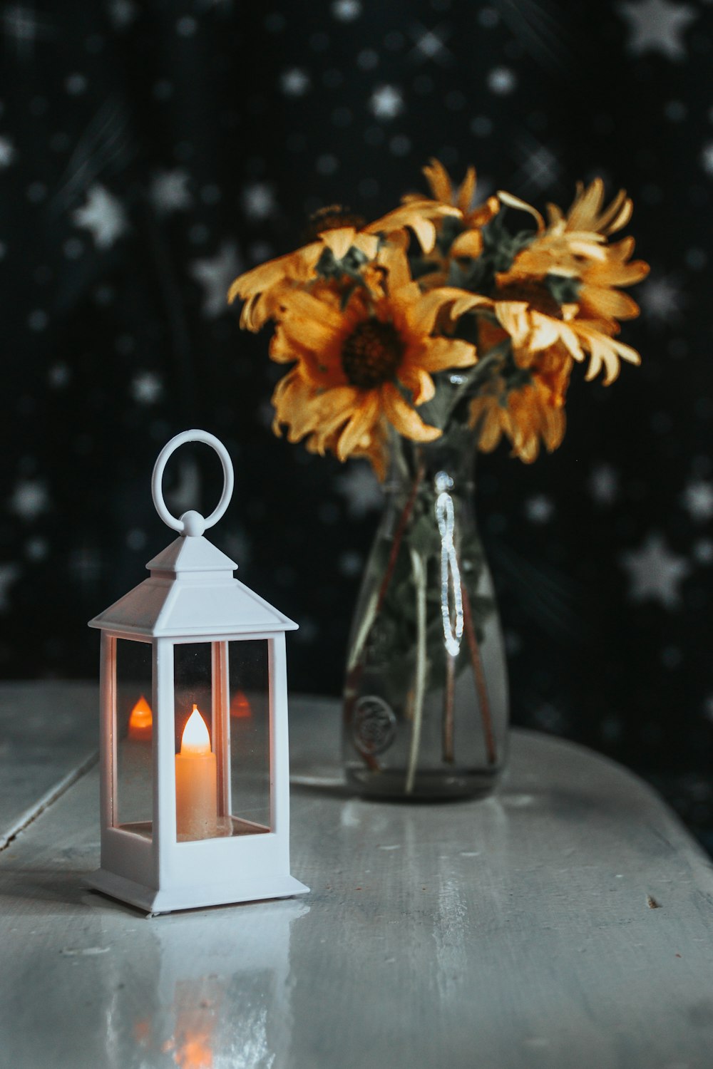 yellow flowers in clear glass vase