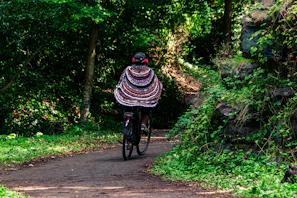 Zaza riding a whimsical bike through a sparkling, candy-colored forest.