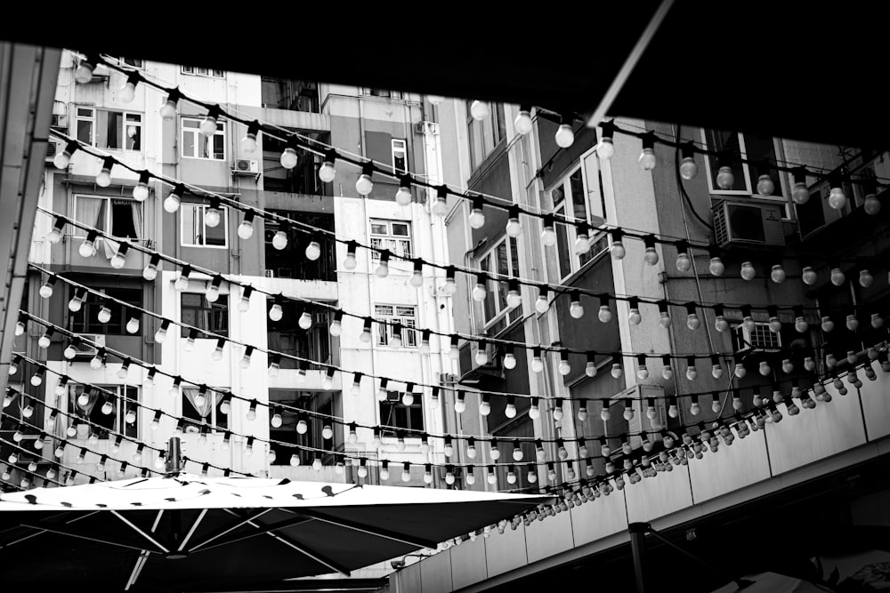 a black and white photo of a building with lights on it