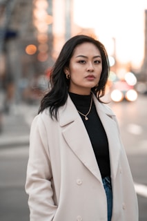 woman in white blazer standing on road during daytime