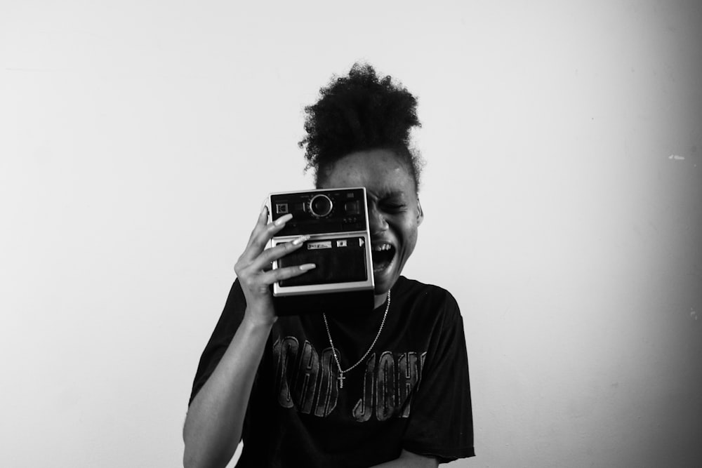 grayscale photo of man holding camera