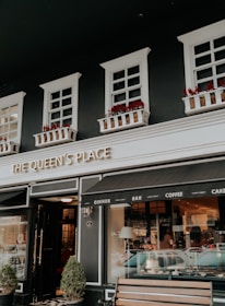 Storefront of Universal Kings and Queens showing welcoming entrance and signage.