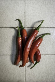 red chili peppers on white ceramic tiles