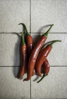 red chili peppers on white ceramic tiles