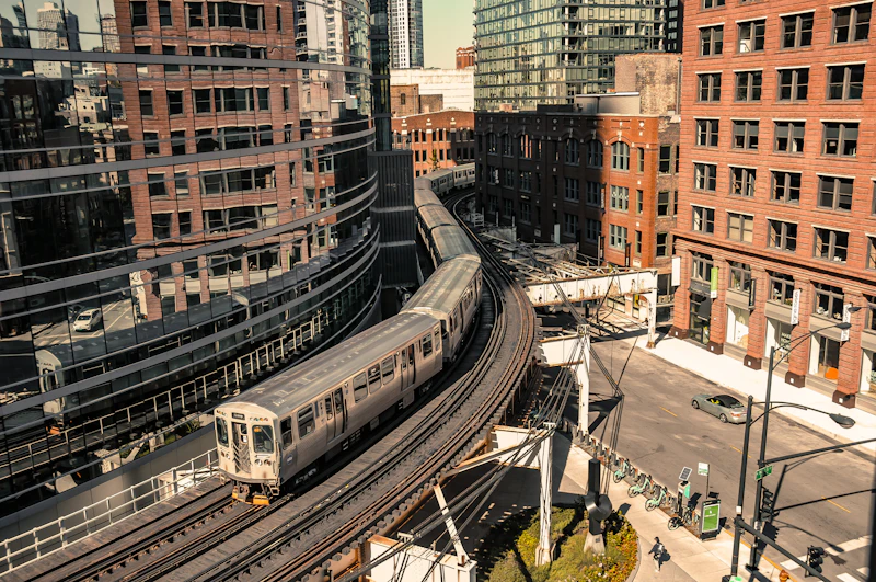 Aerial view of a CTA train curving through the Loop elevated tracks