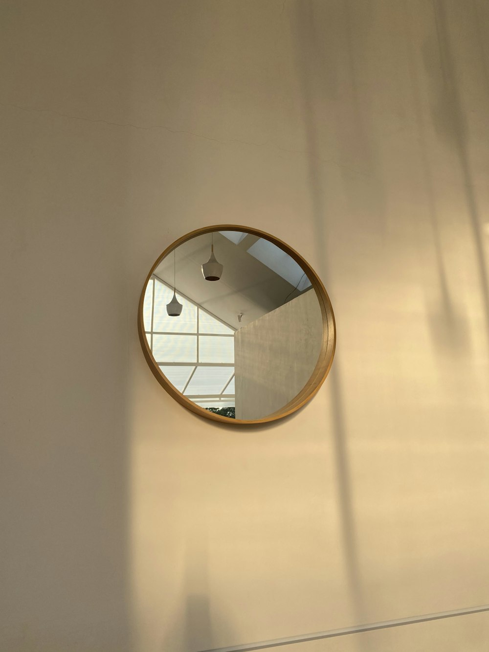 round mirror with brown wooden frame