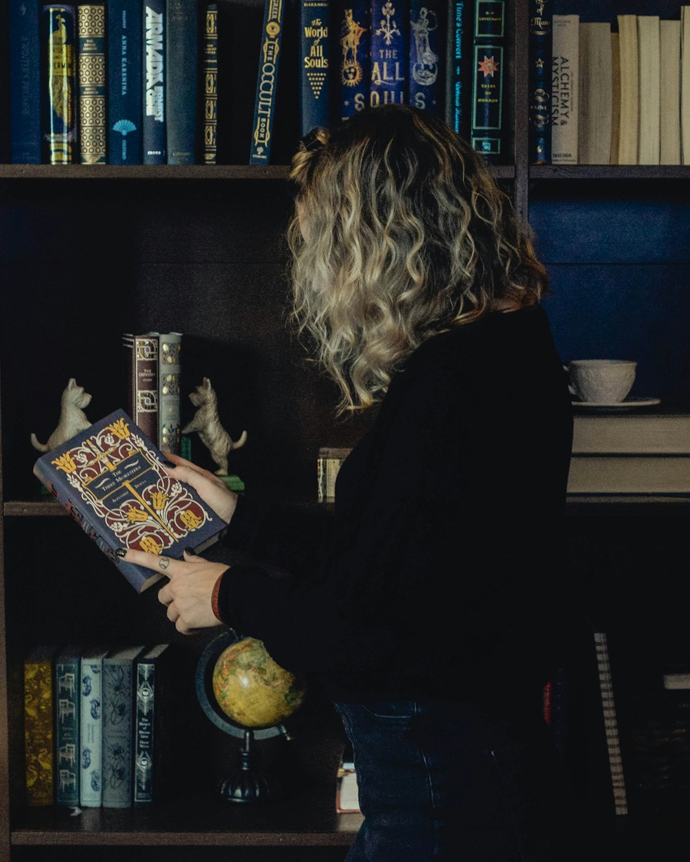 woman in black long sleeve shirt holding book