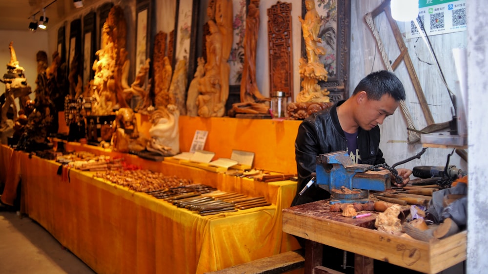 man in blue long sleeve shirt standing in front of food display counter