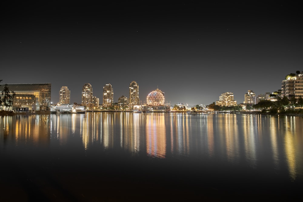 city lights reflecting on water during night time