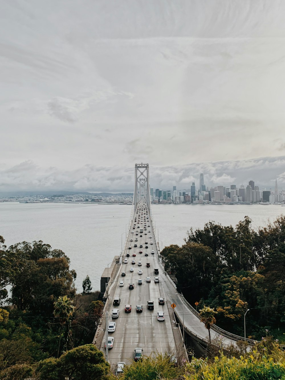 gray concrete bridge near body of water during daytime