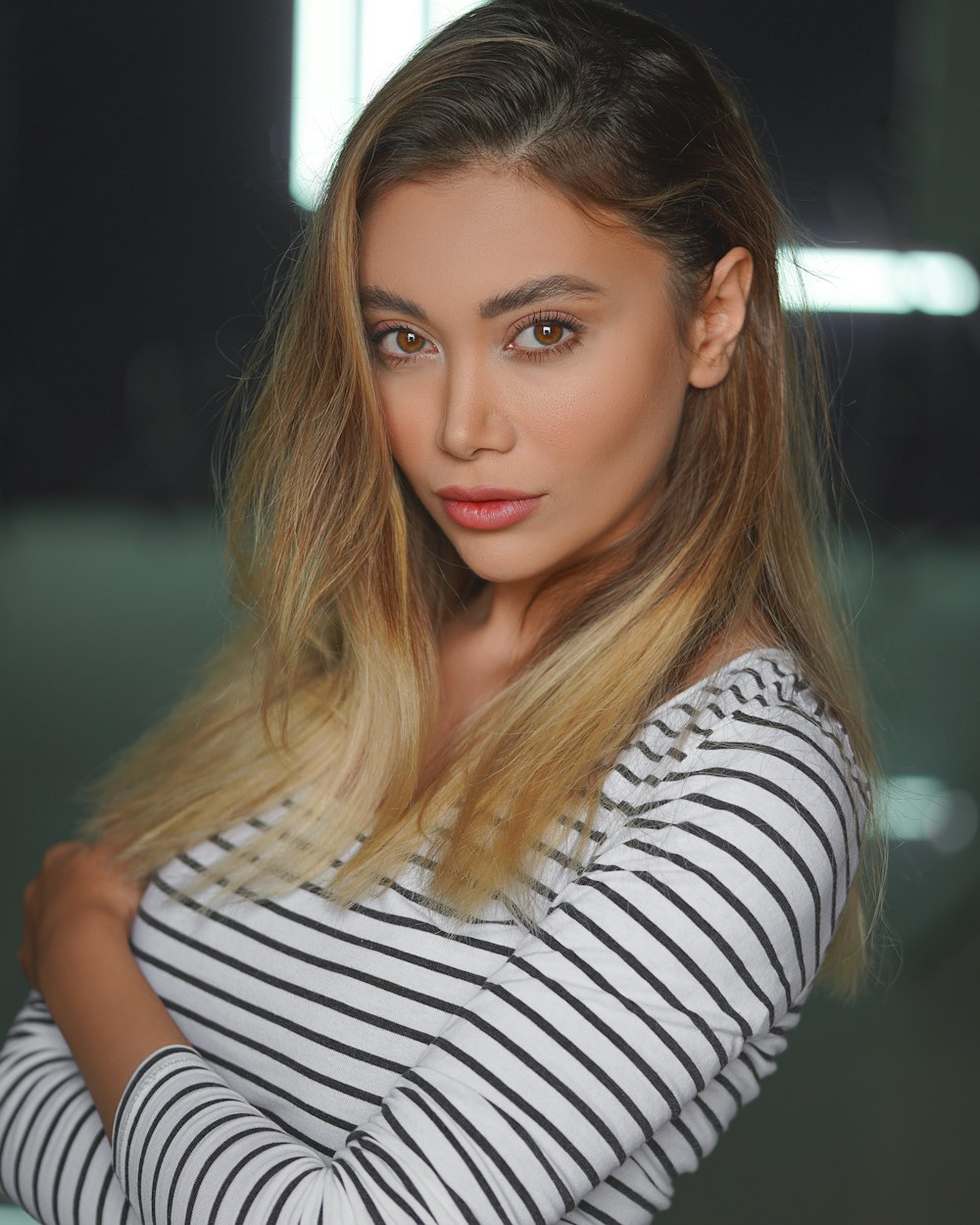 woman in white and black striped shirt