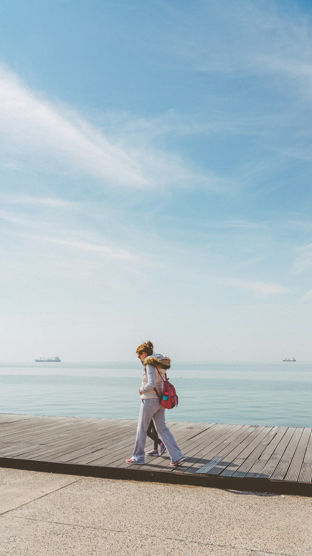 woman in white dress standing on beach during daytime