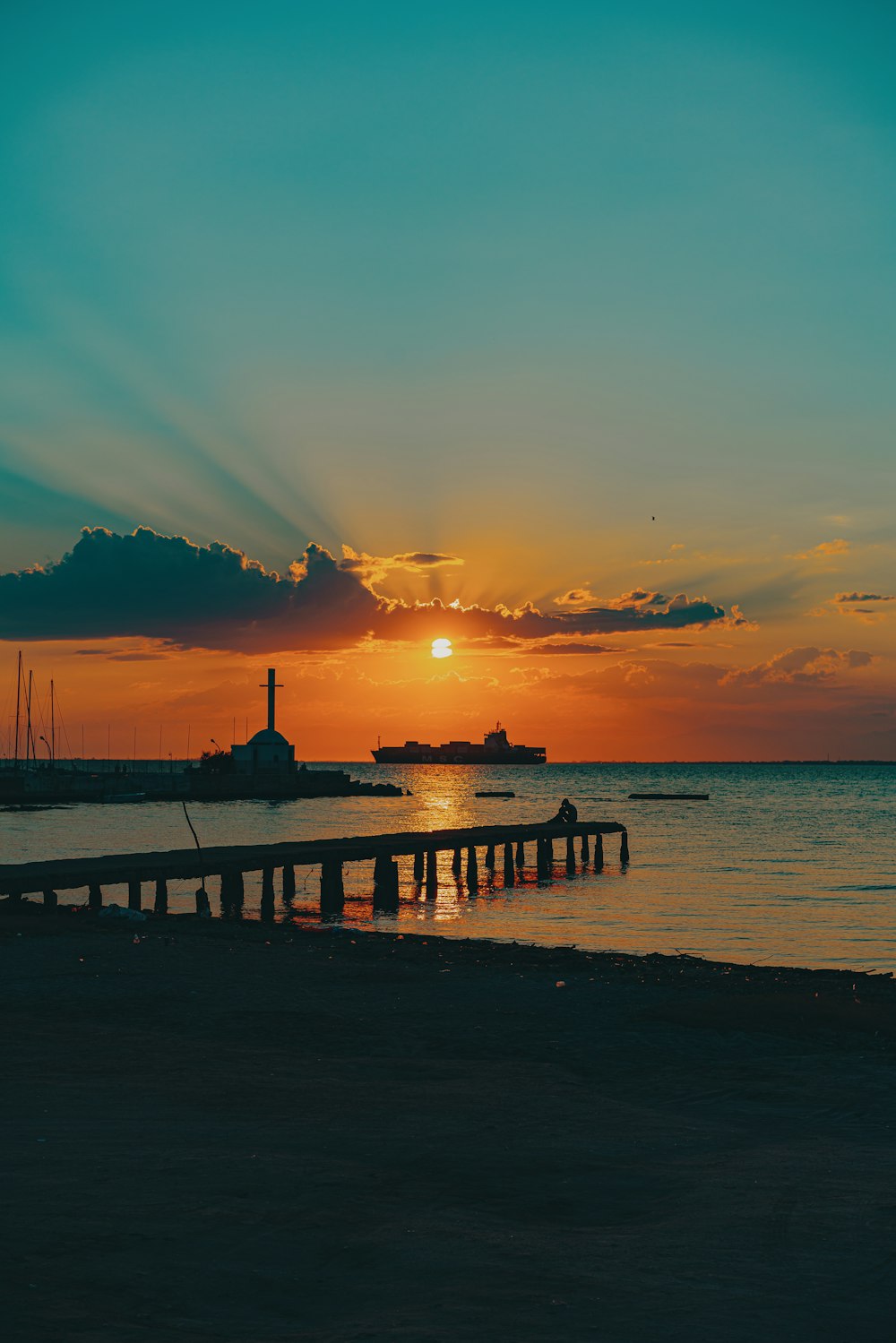 silhouette of people on dock during sunset