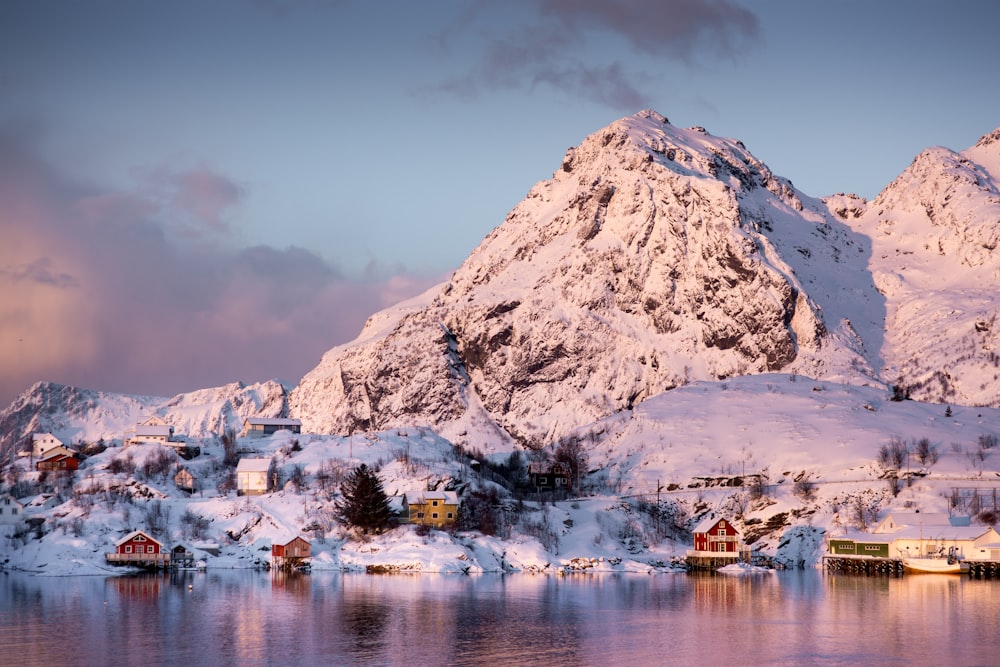 white and brown mountain near body of water during daytime