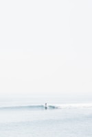 person surfing on sea waves during daytime