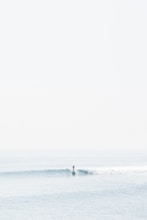 person surfing on sea waves during daytime