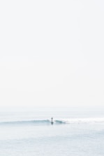 person surfing on sea waves during daytime