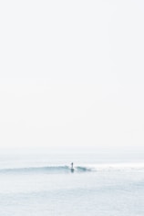 person surfing on sea waves during daytime