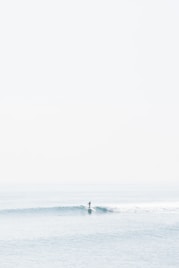 person surfing on sea waves during daytime