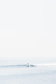 person surfing on sea waves during daytime