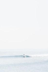 person surfing on sea waves during daytime