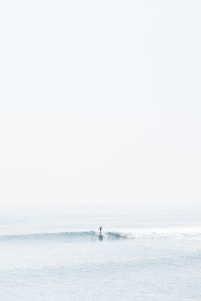 person surfing on sea waves during daytime
