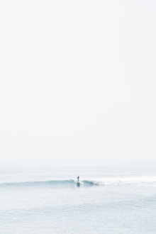 person surfing on sea waves during daytime