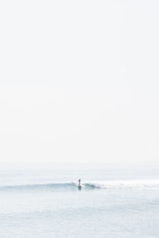 person surfing on sea waves during daytime