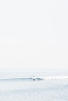 person surfing on sea waves during daytime