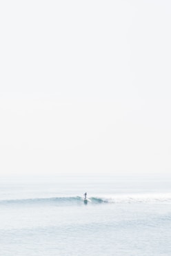 person surfing on sea waves during daytime