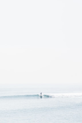 person surfing on sea waves during daytime