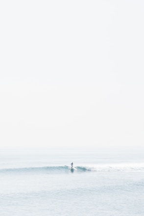 person surfing on sea waves during daytime
