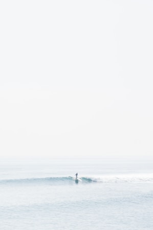 person surfing on sea waves during daytime