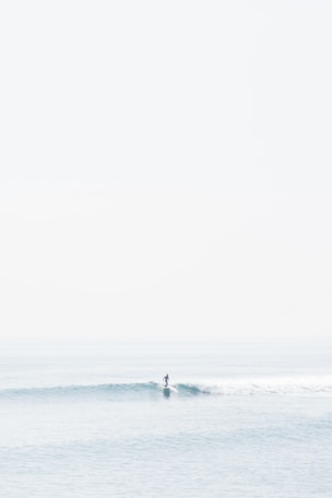 person surfing on sea waves during daytime