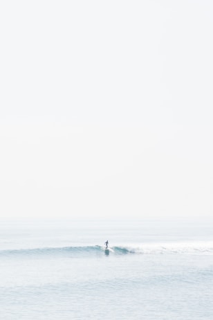 person surfing on sea waves during daytime